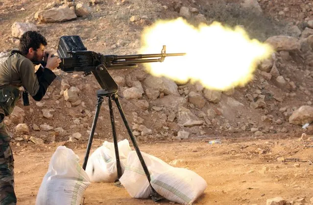 A rebel fighter fires towards pro-regime forces during clashes in Sheikh Najar area of the restive Syrian city of Aleppo on February 24, 2014. (Photo by Zein Al-Rifai/AFP Photo/Aleppo Media Centre)