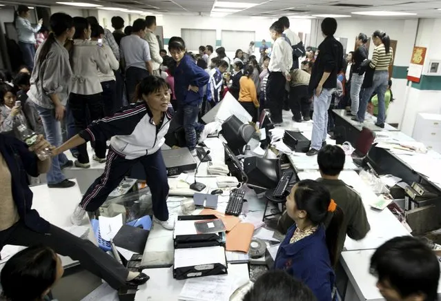 Factory workers smash up an office during a protest at Kaida toy factory in Dongguan, Guangdong province, in this November 25, 2008 file photo. (Photo by Reuters/Stringer)
