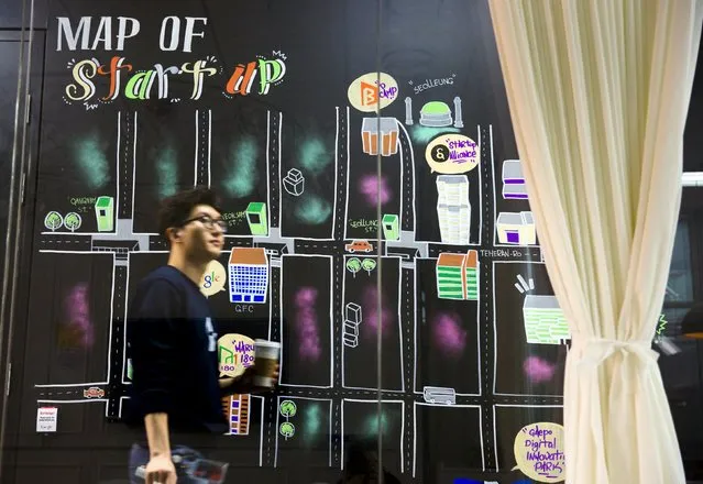A man walks past a wall painting labelled the “Map of Start-up” at the Google Campus start-up space in the Gangnam district of Seoul, May 8, 2015. Google opened on Friday its “Campus” start-up space in Seoul where it will offer work spaces and mentoring for young Asian tech entrepreneurs, representatives of the internet firm said during a presentation. (Photo by Thomas Peter/Reuters)