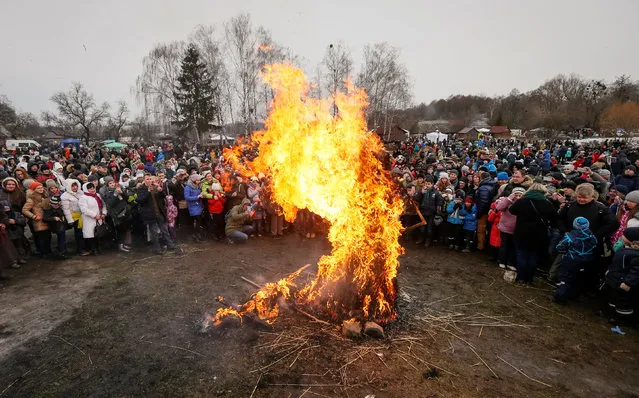 Revellers burn an effigy of Kostrubatyi Did, a symbol of winter, during the celebration of Maslenitsa also known as Kolodiy, a pagan holiday marking the end of winter, in Kiev, Ukraine, February 26, 2017. (Photo by Vasily Fedosenko/Reuters)