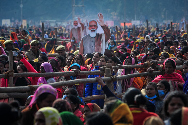 Women from various districts are seen near cut-outs of India's Prime Minister Narendra Modi at a rally held by Modi on December 21, 2021 in Allahabad, India. Modi visited the governing Bharatiya Janata Party (BJP)'s strongholds in Uttar Pradesh, as India's economy emerges from Covid-19 and against the backdrop of sectarian tensions within the country increasing. Modi held the rallies as part of his “Vision of Prime Minister to empower the women” campaign in which the campaign transfers money to the accounts of self-help groups, benefiting around 1.6 million women members of the groups, local media said. (Photo by Ritesh Shukla/Getty Images)