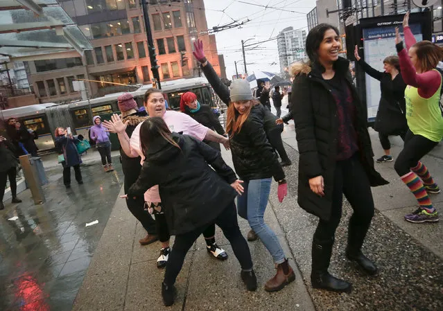 Women participate in a flash mob dance to celebrate the International Women's Day in Vancouver, Canada, March 7, 2017. (Photo by Liang Sen/Xinhua/Barcroft Images)