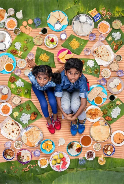 Tharkish Sri Ganesh (right), 10 and Mierra Sri Varrsha, 8, Kuala Lumpur, Malaysia, 2017: Tharkish and Mierra live with their mum and dad in a public housing project in Bukit Jalil, a suburb of Kuala Lumpur. Their apartment block is full of friends and noisy, in a good way. Their dad works as a gaffer in film production and their mum is a homemaker and does most of the cooking, although on weekends, they eat KFC, Pizza Hut or Chinese takeaway. (Photo by Gregg Segal/The Guardian)