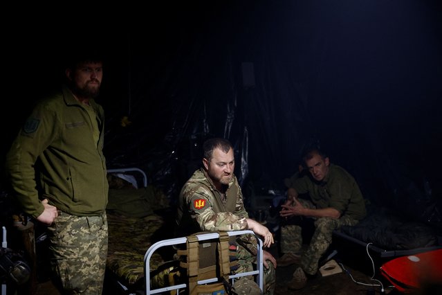 Ukrainian servicemen of the 42nd Separate Mechanized Brigade wait for a combat work inside a dugout at a position near a border, amid Russia's attack on Ukraine, in Kharkiv region, Ukraine on May 16, 2024. (Photo by Valentyn Ogirenko/Reuters)