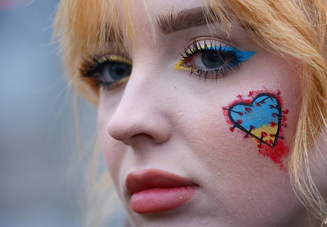 Protester looks on ahead of a protest to mark the one-year anniversary of the Russian invasion of Ukraine at the Brandenburg Gate, in Berlin, Germany on February 24, 2023. (Photo by Fabrizio Bensch/Reuters)