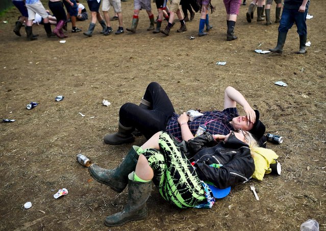 Revellers relax in front of the Other stage at Worthy Farm in Somerset during the Glastonbury Festival in Britain, June 27, 2015. (Photo by Dylan Martinez/Reuters)