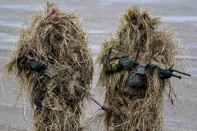 Two snipers of the German army Bundeswehr present their weapons during German Defence Minister Christine Lambrecht's visit to Munster military base, in Munster, Germany, February 7, 2022. (Photo by Fabian Bimmer/Reuters)
