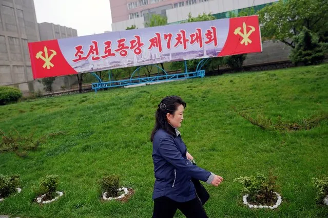 A woman walks in front of a banner announcing Workers' Party of Korea (WPK) congress placed near April 25 House of Culture, the venue of the congress in Pyongyang, North Korea May 6, 2016. (Photo by Damir Sagolj/Reuters)