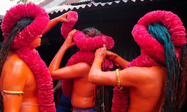 Performers are getting ready for Lal Kach Hindu Festival in Dhaka, Bangladesh on April 13, 2017. The Lal Kach festival is well known for the local community for more than hundred years. The Hindu youth and men paint themselves with red color and attend a procession holding swords as they show power against evil and welcome the Bengali New Year 1424 on April 14, 2017. (Photo by Mushfiqul Alam/ZUMA Wire/Rex Features/Shutterstock)