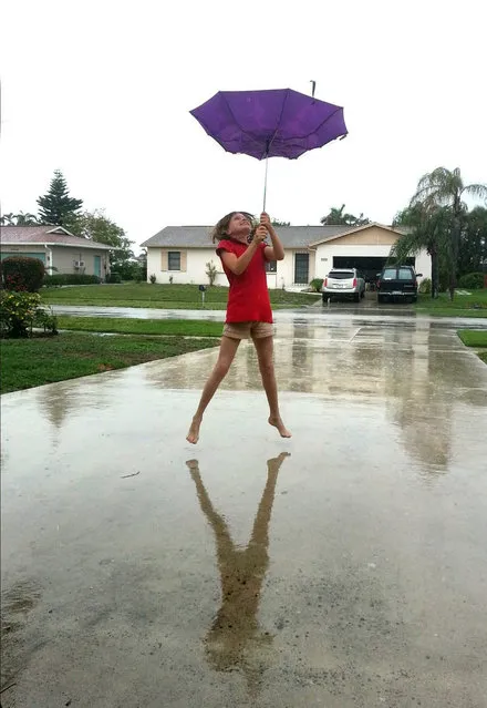 Point & Shoot Challenge: “April Showers” photo by Nancy Nash of Marco Island. It was a rainy day and her daughter, Elizabeth, was playing in the driveway. (Photo by Nancy Nash)