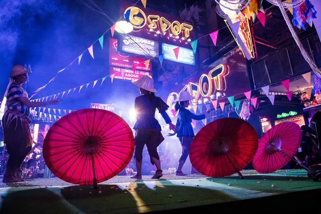 This photo taken on March 29, 2017 shows performers dancing on a stage set up in a red light district of Pattaya at an event used to highlight a push by the city to promote safety in the area. (Photo by Roberto Schmidt/AFP Photo)