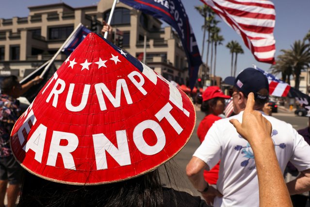 A demonstrator wears a hat reading “Trump Fear Not” as Pro-Trump supporters gather during a demonstration in support of former President Donald Trump who was shot the previous day in an assassination attempt during a rally in Pennsylvania, in Huntington Beach, California on July 14, 2024. (Photo by Etienne Laurent/Reuters)