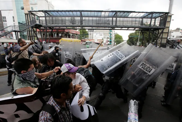 Riot police clash with protesters during a demonstration against bullfights outside a bullring in Mexico City, Mexico May 29, 2016. (Photo by Henry Romero/Reuters)