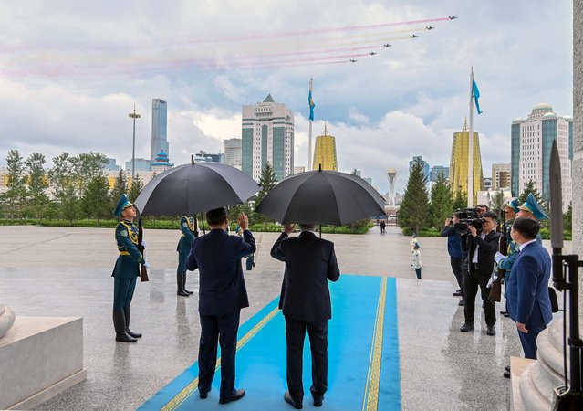 In this handout picture released by Kazakhstan's presidential press service on July 3, 2024, Kazakh President Kassym-Jomart Tokayev and visiting China's President Xi Jinping attend a welcoming ceremony prior to their talks in Astana. (Photo by Handout/Kazakhstan's presidential press service/AFP Photo)