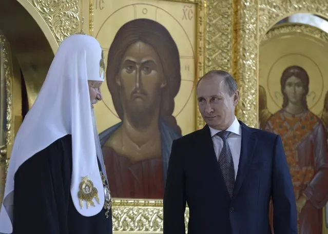 Russian President Vladimir Putin (R) listens to Patriarch of Moscow and All Russia Kirill at the recently renovated St. Prince Vladimir Cathedral during a celebration of 1000 year anniversary of the Great Prince Vladimir canonization in Moscow, Russia, July 27, 2015. (Photo by Alexei Nikolsky/Reuters/RIA Novosti/Kremlin)