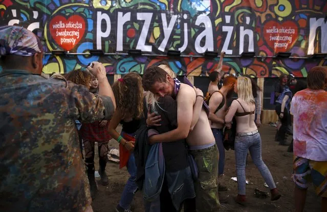 A couple hugs near the main stage during the 21st Woodstock Festival in Kostrzyn-upon-Odra, Poland July 30, 2015. (Photo by Kacper Pempel/Reuters)