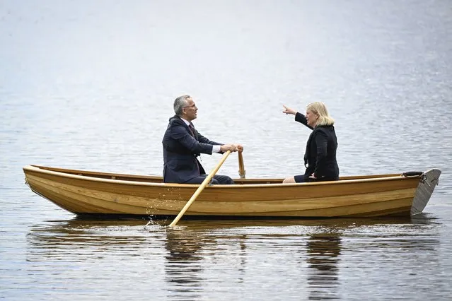 Sweden's Prime Minister Magdalena Andersson, right, and NATO Secretary General Jens Stoltenberg talk on a traditional rowboat during their meeting at Harpsund, the country retreat of Swedish prime ministers, Monday, June 13, 2022. (Photo by Henrik Montgomery/TT News Agency via AP Photo)