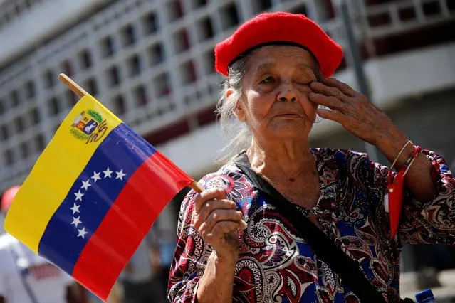 A supporter of Venezuela's President Nicolas Maduro participates in the celebration of the commemorate May Day in Caracas, Venezuela on May 1, 2022. (Photo by Leonardo Fernandez Viloria/Reuters)