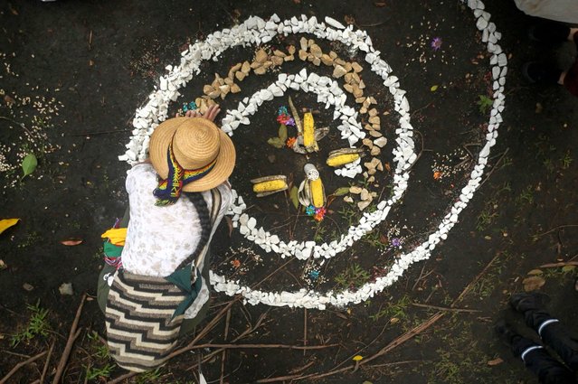 An indigenous man waits at the green zone of the COP16 summit in Cali, Colombia, on October 23, 2024. (Photo by Joaquin Sarmiento/AFP Photo)