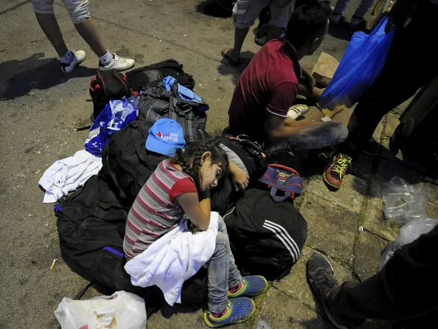 Immigrants sleep at Gevgelija railway station, Macedonia August 19, 2015. (Photo by Ognen Teofilovski/Reuters)