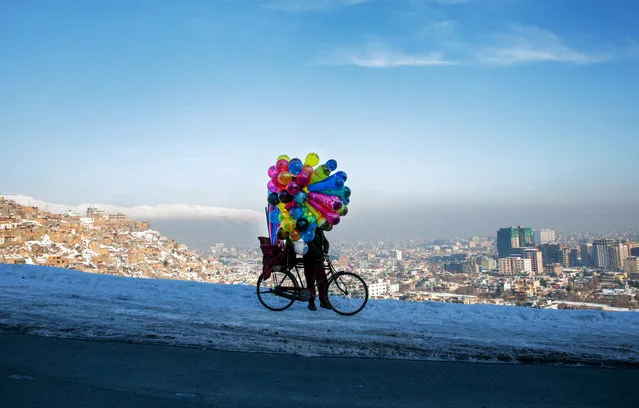 An Afghan balloon vendor looks for customers on a hill top in Kabul, Afghanistan, 15 January 2020. (Photo by Hedayatullah Amid/EPA/EFE)
