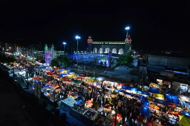 Indian Muslims gather at a market ahead of Eid al-Fitr in the old city section of Hyderabad on July 5, 2016. Like millions of Muslims around the world, Indian devotees celebrate the month of Ramadan by abstaining from eating, drinking, and smoking as well as sexual activities from dawn to dusk. (Photo by Noah Seelam/AFP Photo)