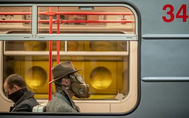 Men wear masks as they sit in the metro in Prague, Czech Republic, 17 March 2020. According to media reports, the Czech government decided to impose a two-week quarantine in the country on the evening of 15 March, and ban all international travel from 16 March 2020. Currently 383 cases of the coronavirus SARS-CoV-2, which causes the Covid-19 disease, have been officially confirmed in Czech Republic. (Photo by Martin Divisek/EPA/EFE)