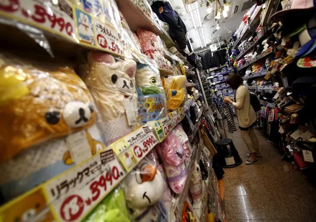 A shopper looks at items inside a discount store at a shopping district in Tokyo, Japan, July 29, 2015. (Photo by Yuya Shino/Reuters)