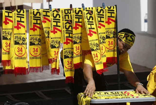 A shopkeeper selling pro-democracy group “Bersih” (Clean) merchandise at the Kuala Lumpur and Selangor Chinese Assembly Hall ahead of their march, in Malaysia's capital city of Kuala Lumpur August 29, 2015. (Photo by Edgar Su/Reuters)