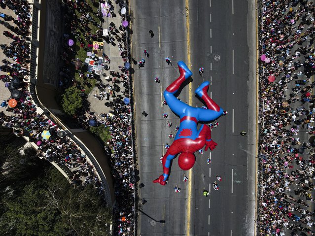 A Spiderman balloon passes through a street during a Christmas festival in Santiago, Chile, Sunday, December 1, 2024. (Photo by Esteban Felix/AP Photo)