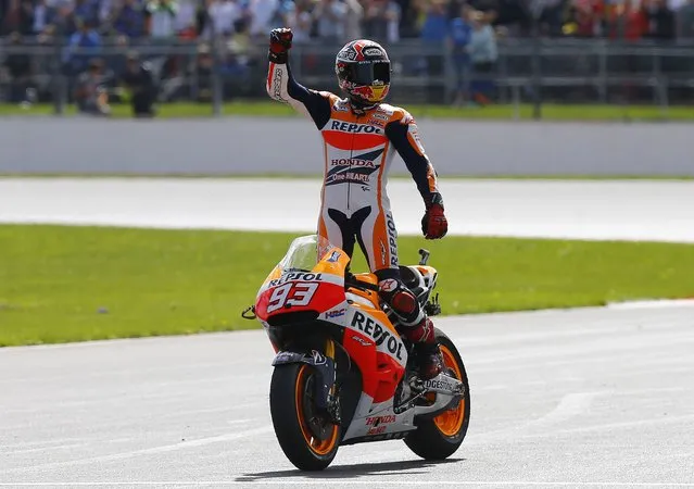 Honda MotoGP rider Marc Marquez of Spain celebrates winning the British Grand Prix at the Silverstone Race Circuit, central England, August 31, 2014. (Photo by Darren Staples/Reuters)