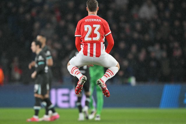 PSV Eindhoven's Dutch midfielder #23 Joey Veerman (C) jumps in the air ahead of the kickoff for the UEFA Champions League, league phase day 8, football match between PSV Eindhoven (NED) and Liverpool FC (ENG) at the the Philips Stadion, in Eindhoven, on January 29, 2025. (Photo by Nicolas Tucat/AFP Photo)