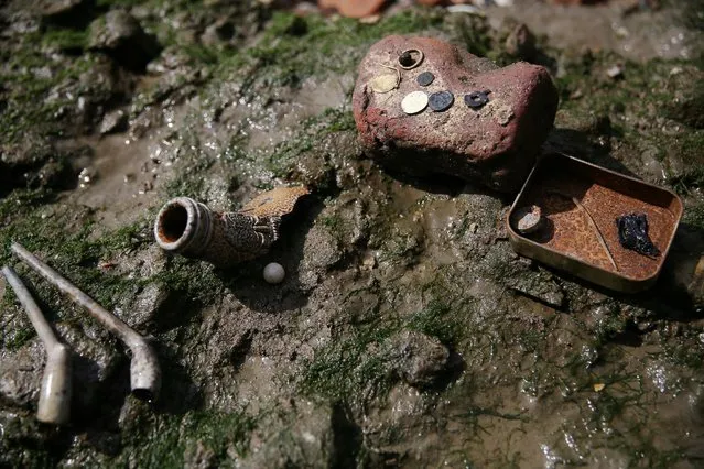 Objects recently excavated by mudlarks Andy Johansen and Ian Smith are presented on the bank of the River Thames in London, Britain May 22, 2016. (Photo by Neil Hall/Reuters)