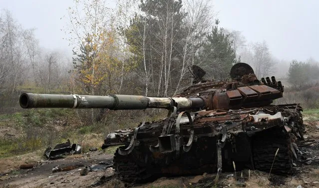 A destroyed Russian tank is seen near the recently recaptured village of Yampil, Ukraine, Wednesday, November 9, 2022. (Photo by Andriy Andriyenko/AP Photo)
