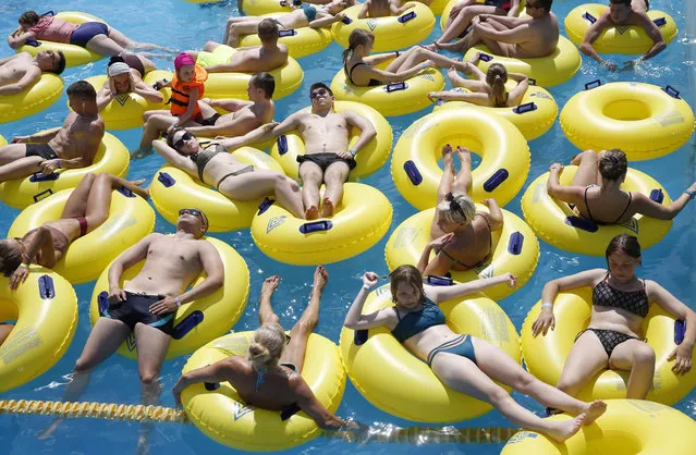 Visitors enjoy a ride at the open-air aquapark “Dreamland” in Minsk, Belarus, 27 June 2020, amid the ongoing pandemic of the COVID-19 disease caused by the SARS-CoV-2 coronavirus. Aquapark 'Dreamland' is considered one of the biggest open-air aquaparks in Europe. Local media report that Minsk is experiencing summer temperatures of up to 30 degrees Celsius. (Photo by Tatyana Zenkovich/EPA/EFE/Rex Features/Shutterstock)