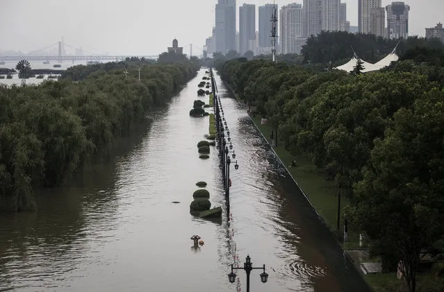 A swimmer wades through flooded water in Jiangtan park, caused by heavy rains along the Yangtze river, on July 13, 2020 in Wuhan,China. The water level at Hankou station on the Wuhan section of the Yangtze River has reached 28.77 meters, the fourth highest in history. (Photo by Getty Images)