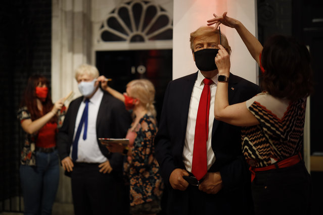 Artists put the finishing touches to wax figures Britain's Prime Minister Boris Johnson and US President Donald Trump as Madame Tussauds prepares to reopen its doors to the public on July 30, 2020 following the easing of coronavirus lockdown restrictions in England. (Photo by Tolga Akmen/AFP Photo)