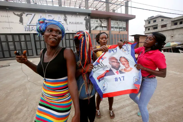 Supporters of George Weah, former soccer player and presidential candidate of Coalition for Democratic Change (CDC), celebrate after the announcement of the presidential election results in Monrovia, Liberia December 28, 2017. (Photo by Thierry Gouegnon/Reuters)