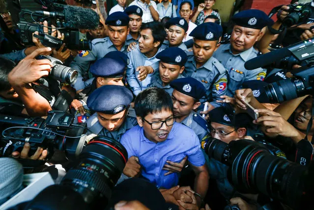 Reuters' journalists Wa Lone (C, front) and Kyaw Soe Oo (C, back) are escorted by police as they leave the court after their first trial in Yangon, Myanmar, 10 January 2018. Reuters journalists Wa Lone and Kyaw Soe Oo were arrested on the outskirts of Yangon city on 12 December 2017 by Myanmar police for allegedly possessing classified police documents. (Photo by Lynn Bo Bo/EPA/EFE)