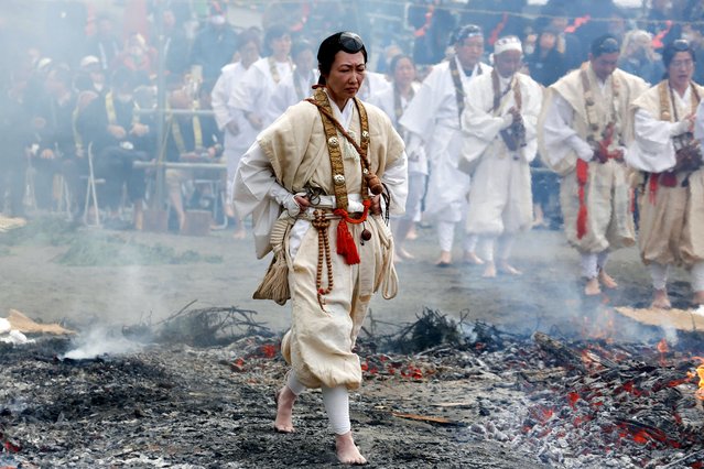 A Buddhist monk walks on the fire during the Hiwatari or fire-walking ceremony at Takao-san Yakuo-in Yuki-ji Temple in Hachioji, Tokyo on March 10, 2024. Buddhist devotees walked over the fire with bare feet to pray for world peace and receive protection from misfortune and good health. Foreign and local visitors participated at the end of the ceremony to receive the benefits. The annual event is held on the second Sunday of March at the down skirt of Mt. Takao. (Photo by Rodrigo Reyes Marin/ZUMA Press Wire/Rex Features/Shutterstock)