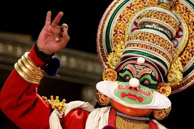 Kalamadalam Shanmukhan performs in a Kathakali at the Indian Cultural Center and Temple in Eads, Tenn., Sunday, November 2, 2014. It takes the actor performing the Indian classical dance drama that dates back to the 17th century five to six hours to get into costume for the performance. Shanmukhan played the role of Ravana from the epic Ramayana. (Photo by Mike Brown/AP Photo/The Commercial Appeal)