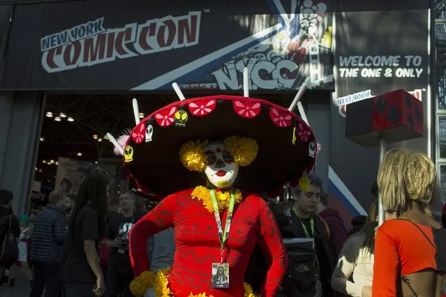 An attendee poses for a picture as New York Comic Con attendees walk through the convention center on Day Three of the event in Manhattan, New York, October 10, 2015. (Photo by Eduardo Munoz/Reuters)