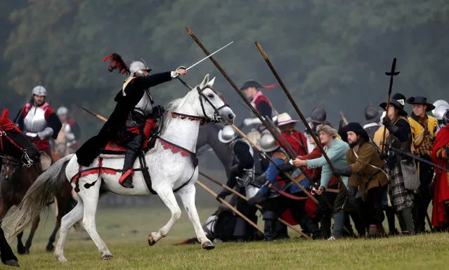 Participants wearing medieval costumes re-enact the 1620 battle of Bila Hora between Bohemian Estates and Austrian Imperial with Catholic forces in Prague, Czech Republic September 18, 2016. (Photo by David W. Cerny/Reuters)