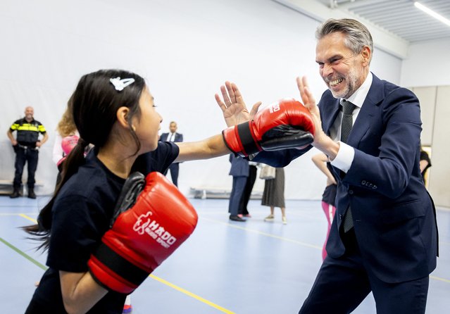 Netherlands' Prime Minister Dick Schoof (R) takes part in a boxing session as he visits a children's centre in Hoogezand on July 9, 2025, during a working visit to the province of Groningen. (Photo by Koen van Weel/ANP via AFP Photo)