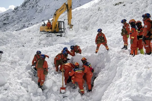 In this photo released by Xinhua News Agency, Rescuers search for survivors following an avalanche in Nyingchi, southwest China's Tibet Autonomous Region on Friday, January 20, 2023. More bodies were found Friday following an avalanche that buried vehicles outside a highway tunnel in Tibet, raising the death toll more than a dozen with several people still missing. (Photo by Sun Fei/Xinhua via AP Photo)