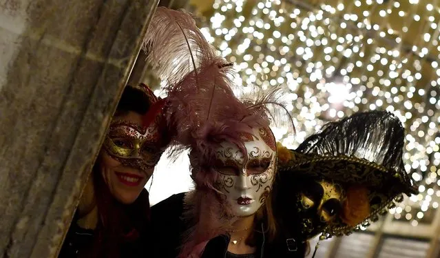 Revellers wearing traditional carnival costume pose in St Mark Square during Venice's Carnival on February 3, 2018. (Photo by Tiziana Fabi/AFP Photo)