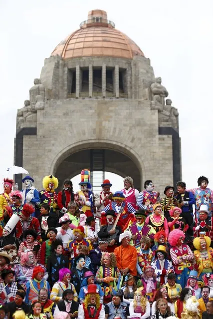 Clowns pose for a photo in front of the Monument to the Revolution during the Latin American Clown Convention in Mexico City, Mexico, October 21, 2015. (Photo by Henry Romero/Reuters)