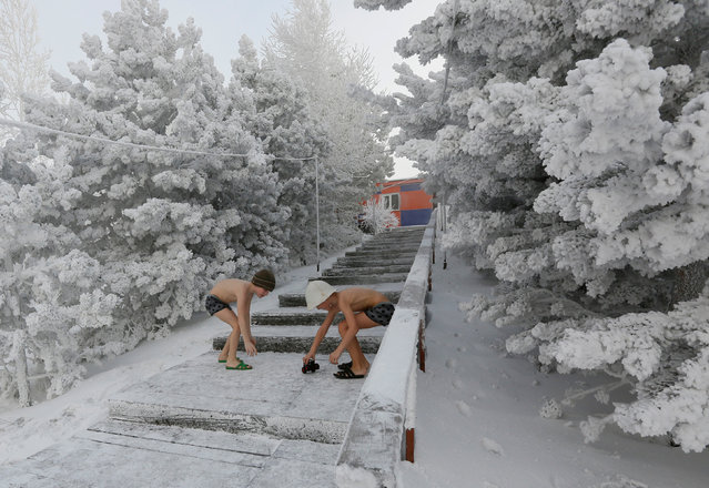 7 years-old twins brothers Miroslav and Timophei Yaroshenko, members of the Cryophile winter swimmers club, play on a bank the Yenisei River covered in snow and hoarfrost, with the air temperature at about minus 38 degrees Celsius (minus 36.4 degrees Fahrenheit), in Krasnoyarsk, Russia on January 19, 2018. (Photo by Ilya Naymushin/Reuters)