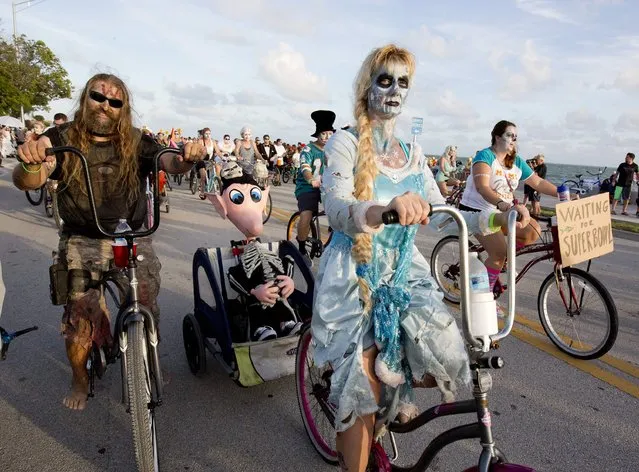 Costumed participants in the Zombie Bike Ride pedal down South Roosevelt Boulevard in Key West, Florida, October 25, 2015. (Photo by Rob O'Neal/Reuters/Florida Keys News Bureau)