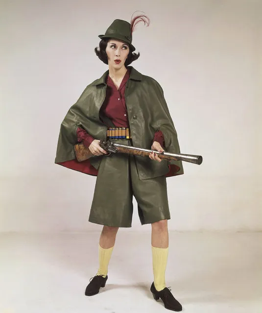 A hunting outfit, consisting of a cape and pant-gown of green glossy leather, with a hat of the same material and a red feather tassel, and worn with a blouse of red silk, the same color as the lining of the cape. It is a creation by the Roland's fashion house of Rome, presented, January 9, 1962. (Photo by Mario Torrisi/AP Photo)